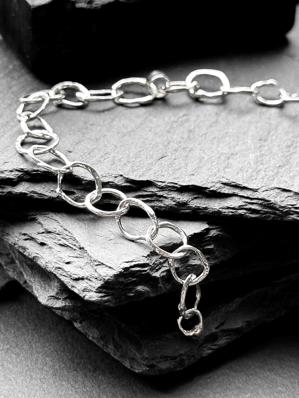 Molten asymmetrical skinny link sterling silver bracelet with single chunky contrasting oval link and T-bar toggle clasp