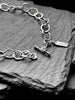 Molten asymmetrical skinny link sterling silver bracelet with single chunky contrasting oval link and T-bar toggle clasp