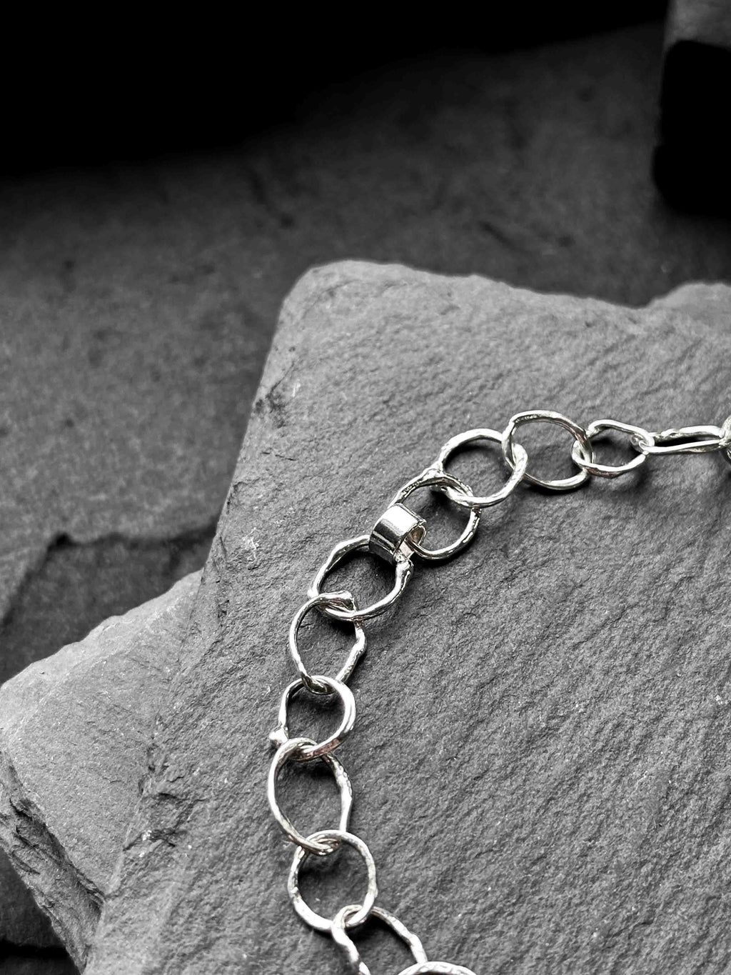 Molten asymmetrical skinny link sterling silver bracelet with single chunky contrasting oval link and T-bar toggle clasp