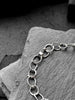 Molten asymmetrical skinny link sterling silver bracelet with single chunky contrasting oval link and T-bar toggle clasp