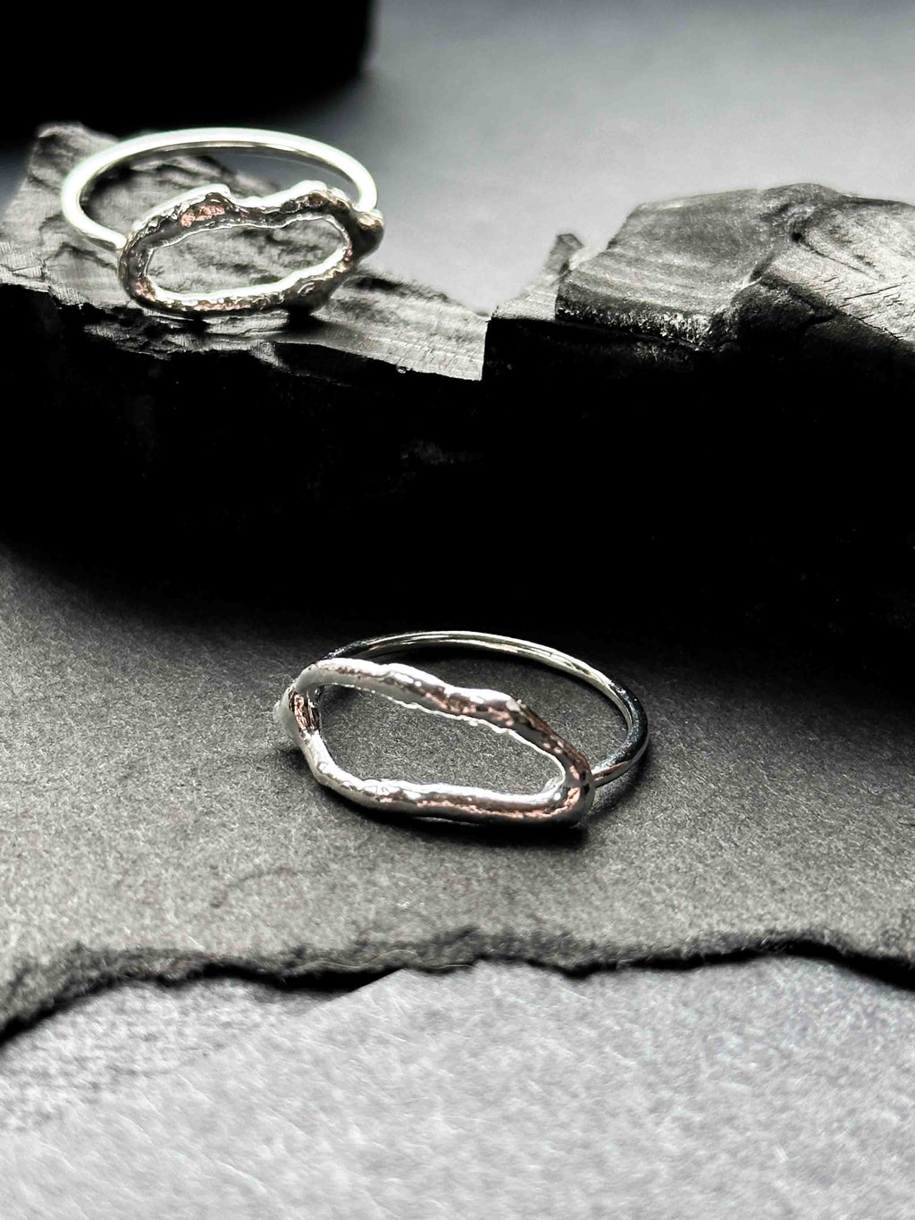 Two textured silver rings with organic, wavy openwork designs. Oval molten texture silver rings.