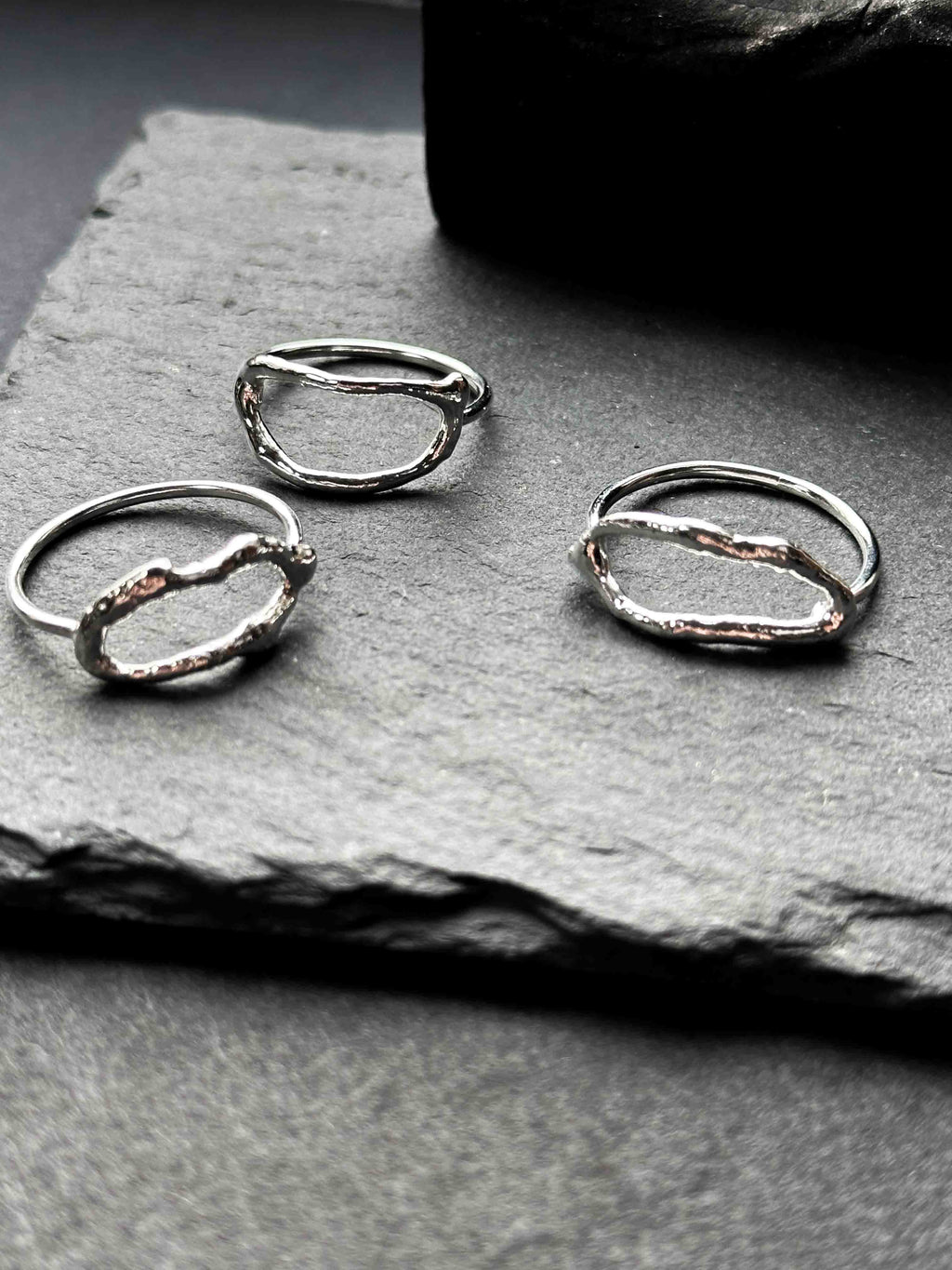 Textured silver rings with organic, wavy openwork designs. Oval molten texture silver rings.