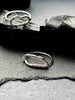 Two textured silver rings with organic, wavy openwork designs. Oval molten texture silver rings.