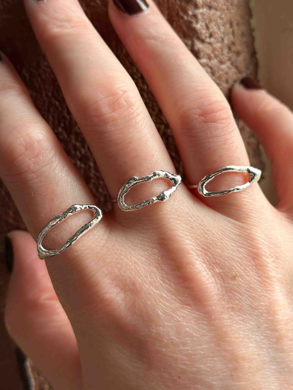 Textured silver rings with organic, wavy openwork designs. Oval molten texture silver rings.