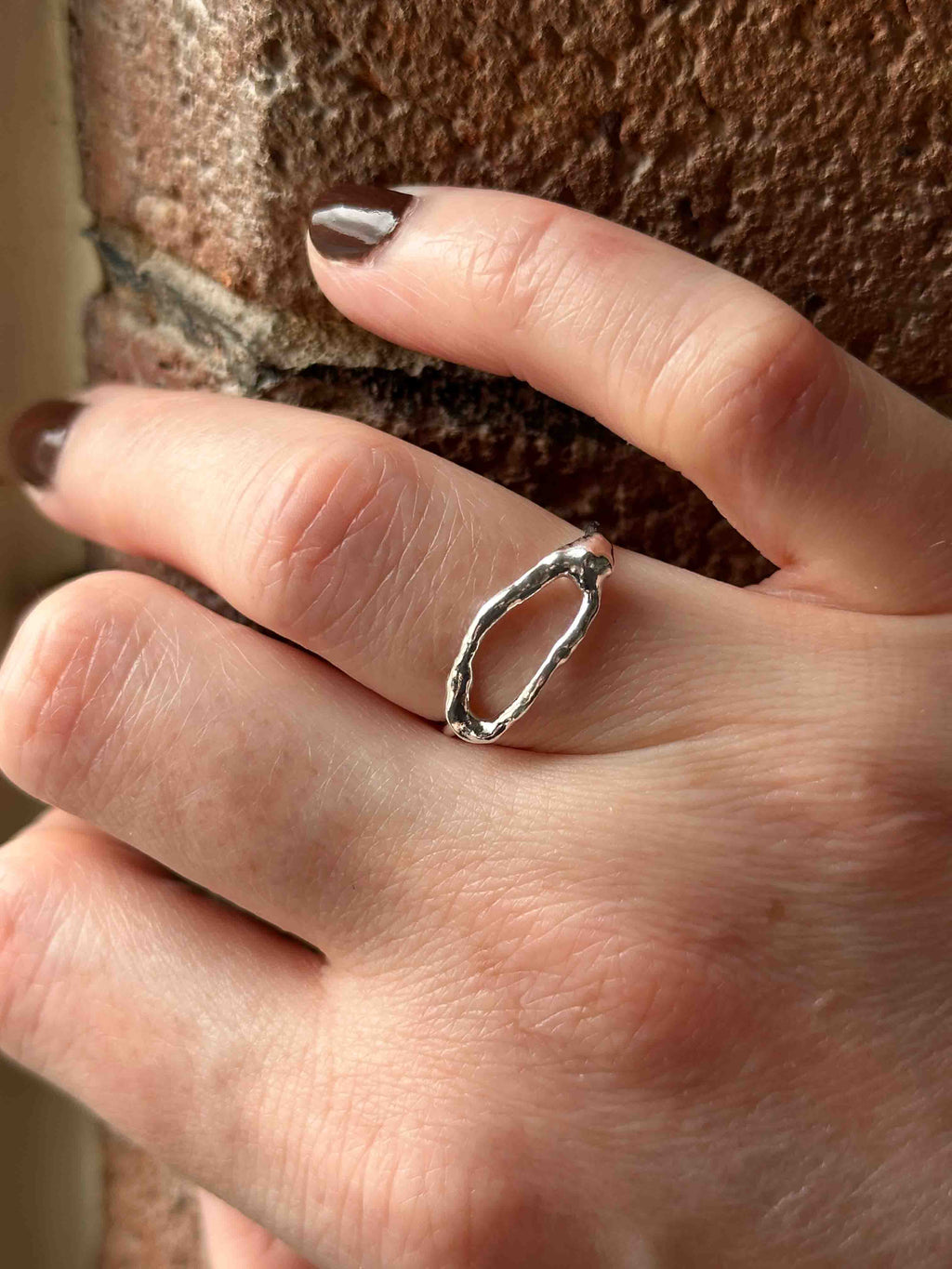 Textured silver ring with organic, wavy openwork designs. Oval molten texture silver ring.