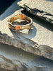 A textured, organic ring, gold wedding band in an alternative style