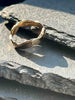 A textured, organic ring, gold wedding band in an alternative style